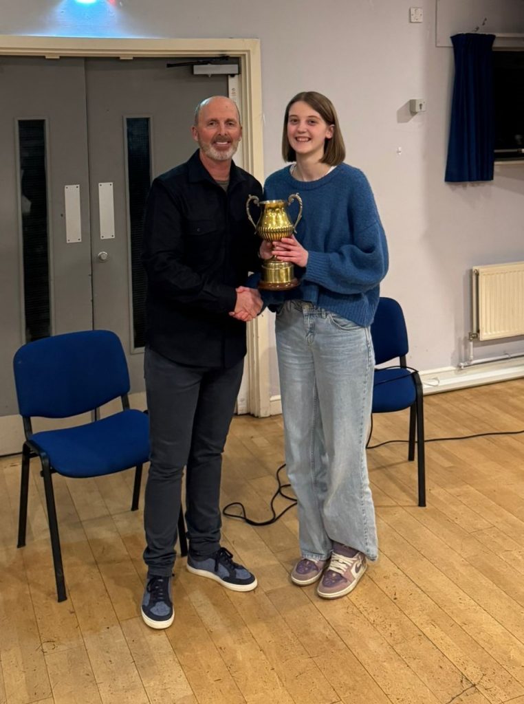 Mike Dean presenting the trophy to Ruby Sykes